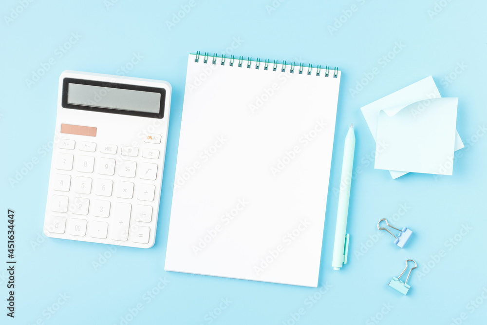 Office desk with calculator, notepad and glasses. Office desk with calculator, notepad and glasses.