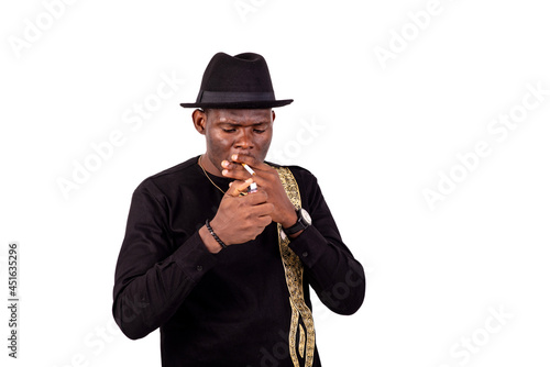 portrait of a handsome businessman lighting a cigarette
