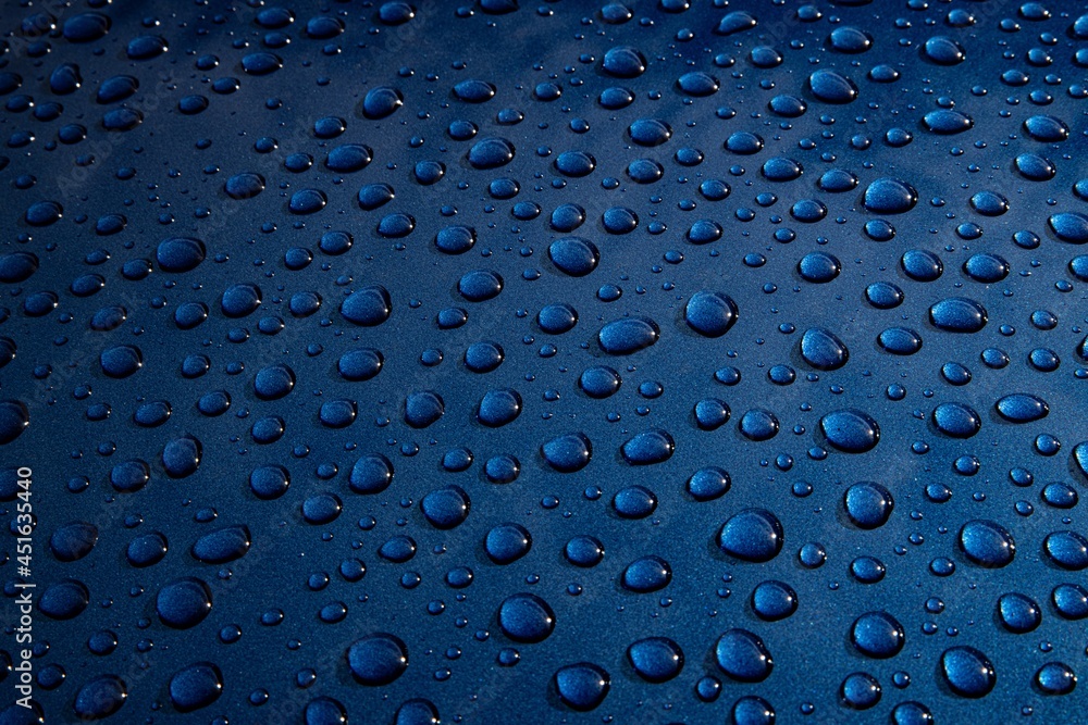 Water drops on metal on car paint. Hydrophobic effect on metal surface
