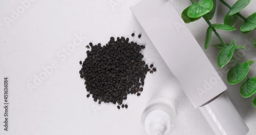 Skincare products with bakuchiol seeds on white background.  photo