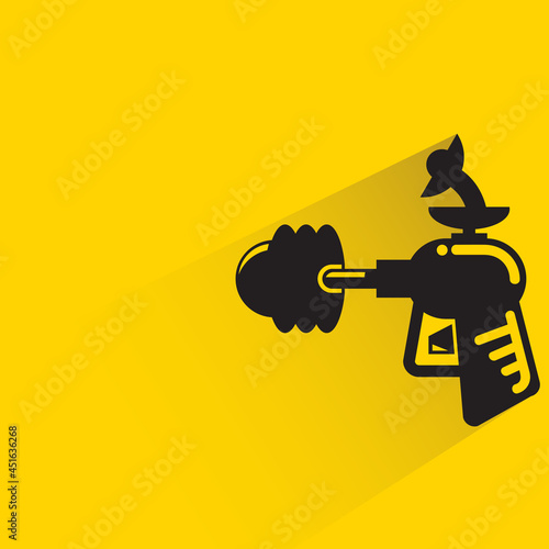 space blaster gun or fantastic raygun icon on yellow background