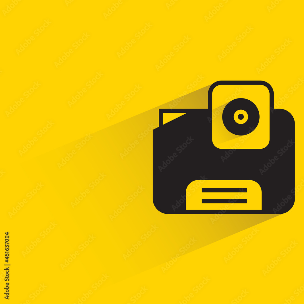 digital camera with shadow on yellow background digital camera with shadow on yellow background