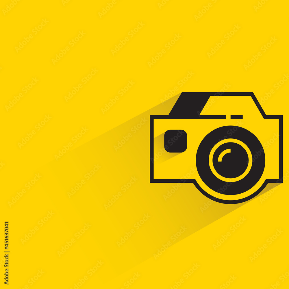digital camera with shadow on yellow background digital camera with shadow on yellow background