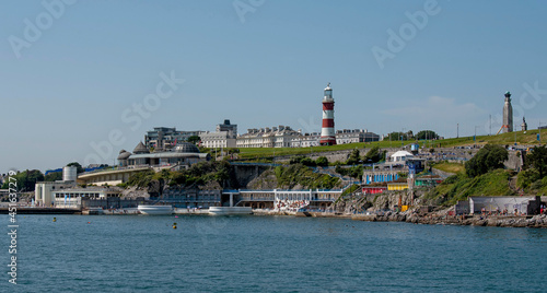 Plymouth, Devon, England, UK. 2021. View of the Plymouth waterfront properties seen from Plymouth Sound viewing Plymouth Hoe, Smeatons Tower and Tinside Lido, leisure area. © petert2