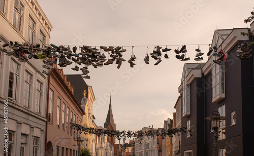old European town street view, cityscape with traditional old German colorful living houses and shoes hanging on wires