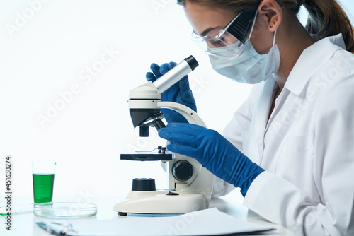 female doctor laboratory research microscope biotechnology professional