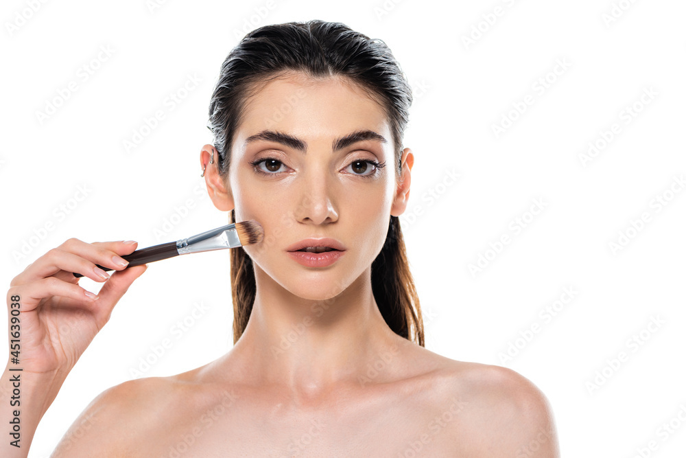 woman applying face foundation with cosmetic brush isolated on white woman applying face foundation with cosmetic brush isolated on white