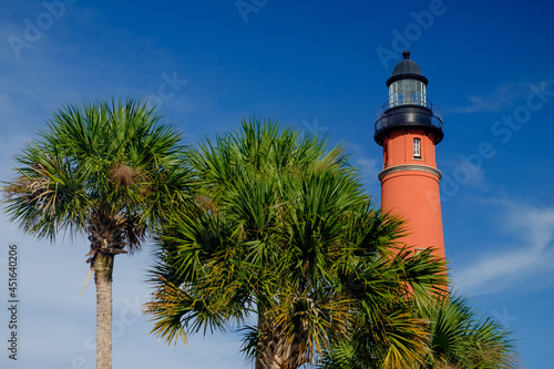 Late afternoon light makes the Ponce De leon Inlet lighthouse and surrounding palm trees glow