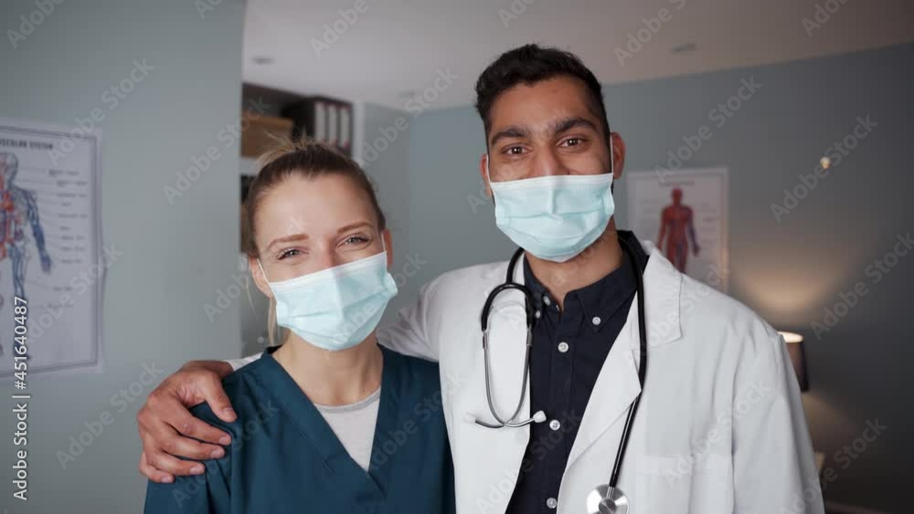 Mixed race doctor friends standing in doctors office Mixed race doctor friends standing in doctors office