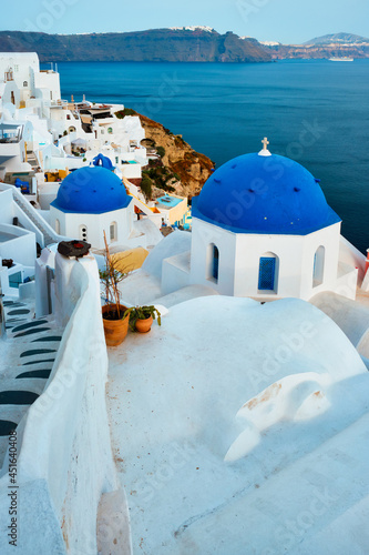 Famous view from viewpoint of Santorini Oia village with blue dome of greek orthodox Christian church © Dmitry Rukhlenko