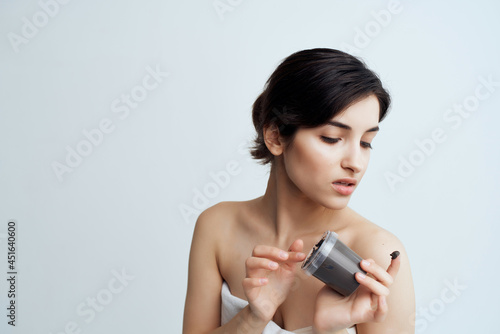 pretty brunette naked shoulders skin care dermatology cream