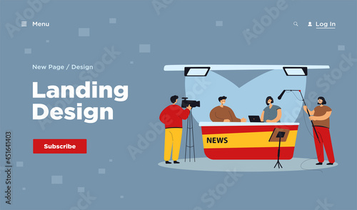 Two journalists sitting at desk on TV studio isolated flat vector illustration. Cartoon professional crew cameraman shooting interview show or news. Entertainment and backstage concept
