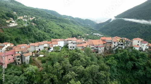 Flight over Italian village in the mountains photo