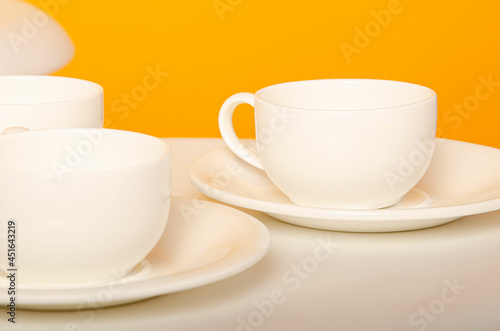 cup on a yellow background. Ceramic mug with saucer for tea or coffee
Place for text
White cup of coffee on a light wooden background. Vintage tones.