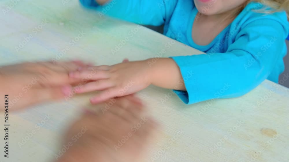 mom plays finger games with daughter, little child, girl 2 years old