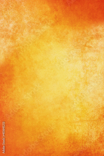 Empty orange and gold background grunge texture in warm autumn colors for Thanksgiving day or Halloween with free space for text.