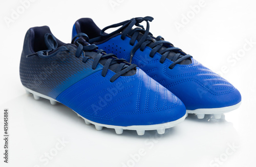 Cuadro en lienzo Pair of new football cleats with studs on outsole designed for playing on grass pitches isolated on white