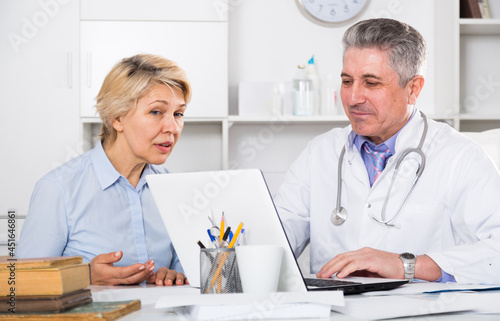 Mature woman visits doctor in hospital for survey and check of your health