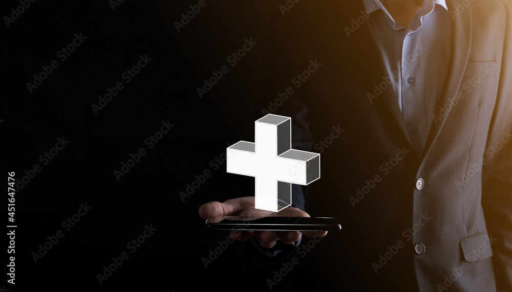 Businessman hold 3D plus icon, man hold in hand offer positive thing such as profit, benefits, development, CSR represented by plus sign.The hand shows the plus sign Businessman hold 3D plus icon, man hold in hand offer positive thing such as profit, benefits, development, CSR represented by plus sign.The hand shows the plus sign