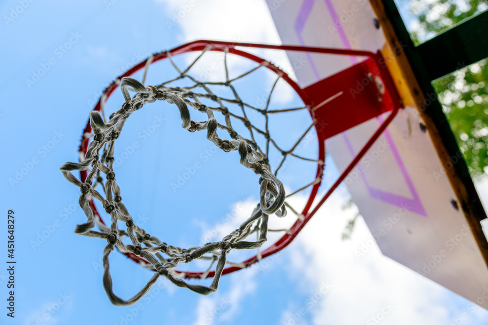 basketball hoop on blue sky background bottom view basketball hoop on blue sky background bottom view