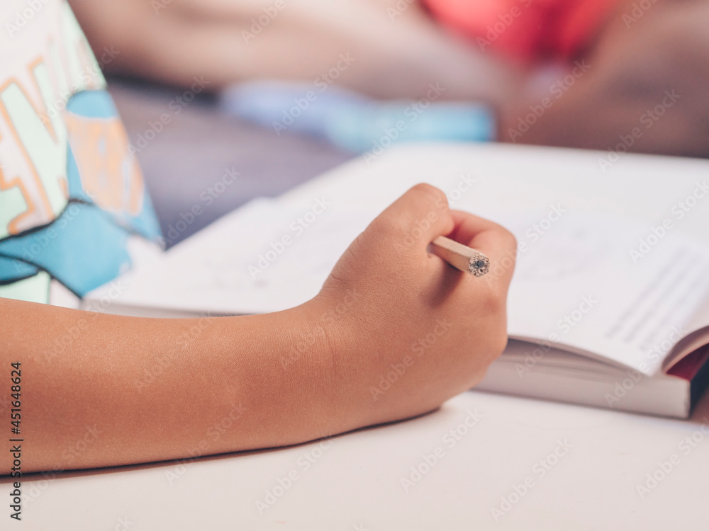 Close-up of child's hand with pencil Close-up of child's hand with pencil