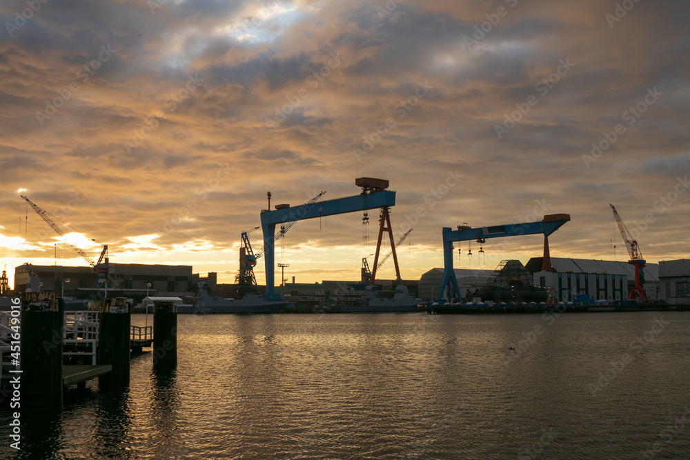 Maritime view to the port of Kiel with shipyard and cranes.