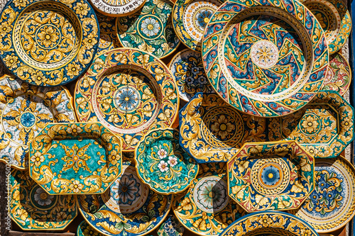 Erice  Sicily. Colorful hand-decorated ceramics. Traditional tourist suvenir. Street vendor with hand made crafts.Plates with ornamental decoration.Summer vacation in Italy travel art scene