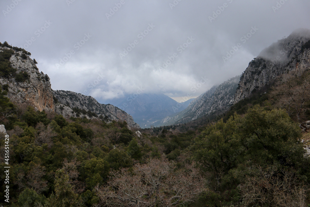 Fototapeta premium view to the valley in the Turkey mountains with ancient abandoned city Termessos