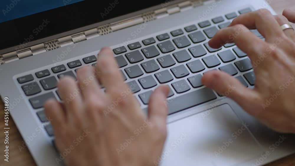 Male hands of business man professional user worker using typing on laptop notebook keyboard sit at home office desk working online with pc software apps technology concept, close up side view Male hands of business man professional user worker using typing on laptop notebook keyboard sit at home office desk working online with pc software apps technology concept, close up side view