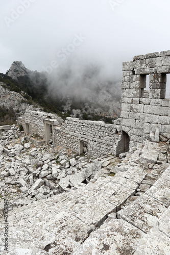 scenic amazing picturesque view to ancient theatre of Termessos , Turkey in the low clouds photo