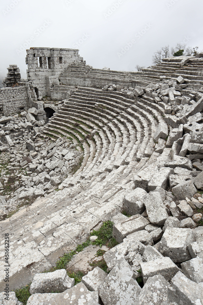 scenic amazing picturesque view to ancient theatre of Termessos , Turkey in the low clouds