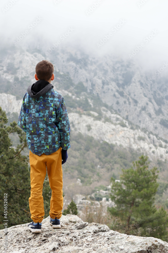 young tourist boy looking to the ruins of ancient Pisidian city Termessos in Turkey