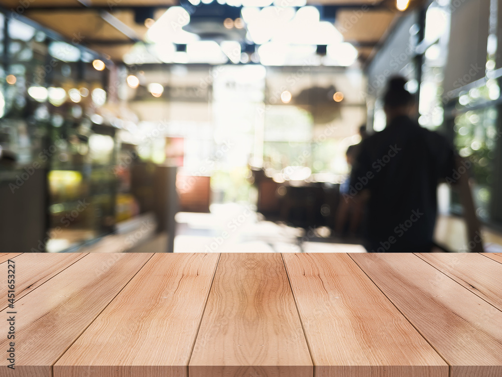 Empty wooden table top with lights bokeh on blur restaurant background. Empty wooden table top with lights bokeh on blur restaurant background.