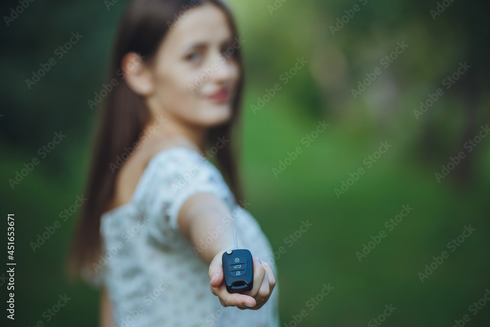 Young beautiful girl holding car keys in hand