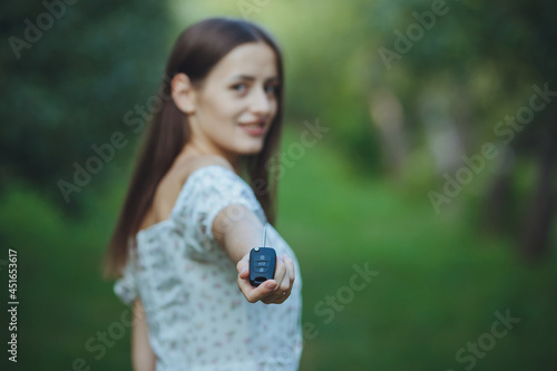 Young beautiful girl holding car keys in hand
