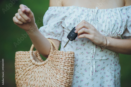 The girl takes out the car keys from her purse