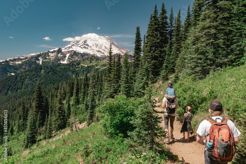 Young women hiking with kids toward Mt Rainier on the Naches Peak Loop Trail in Mt. Rainier National Park