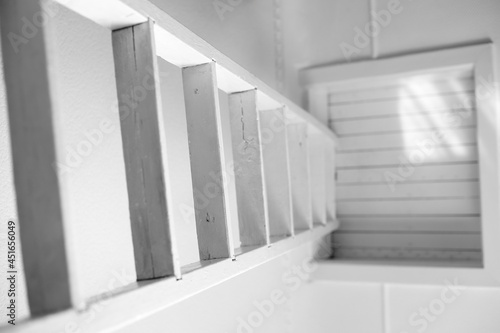 White old staircase to a closed wooden attic