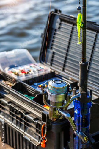 A large fisherman's tackle box fully stocked with lures and gear for fishing.fishing lures and accessories in the box background.