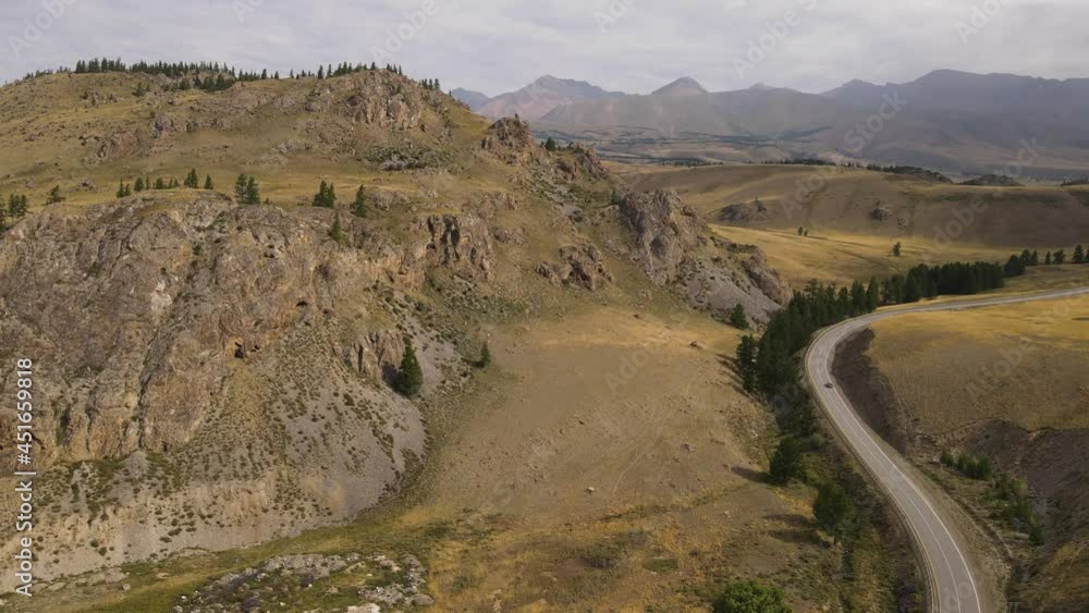 Flying along the Chuisky tract to the beautiful hills. Amazing view, beautiful sky. Altai Mountains, Russia Flying along the Chuisky tract to the beautiful hills. Amazing view, beautiful sky. Altai Mountains, Russia