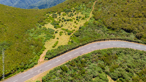 Drop down view of a road bend running through countryside.