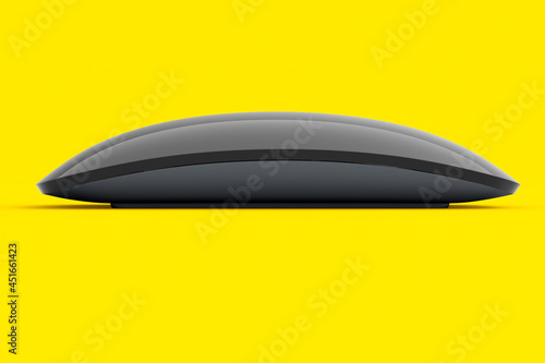 Realistic black wireless computer mouse with touch isolated on yellow background