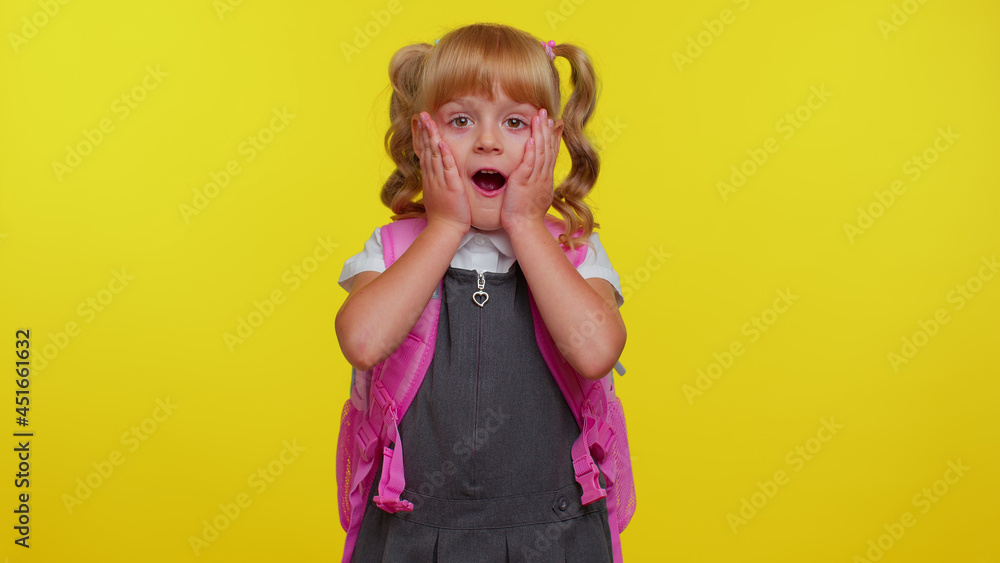 Oh my God, wow. Excited lovely little blonde teen child kid girl in school uniform raising hands in surprise looking at camera with big eyes, shocked by sudden victory. Back to school. Childhood Oh my God, wow. Excited lovely little blonde teen child kid girl in school uniform raising hands in surprise looking at camera with big eyes, shocked by sudden victory. Back to school. Childhood