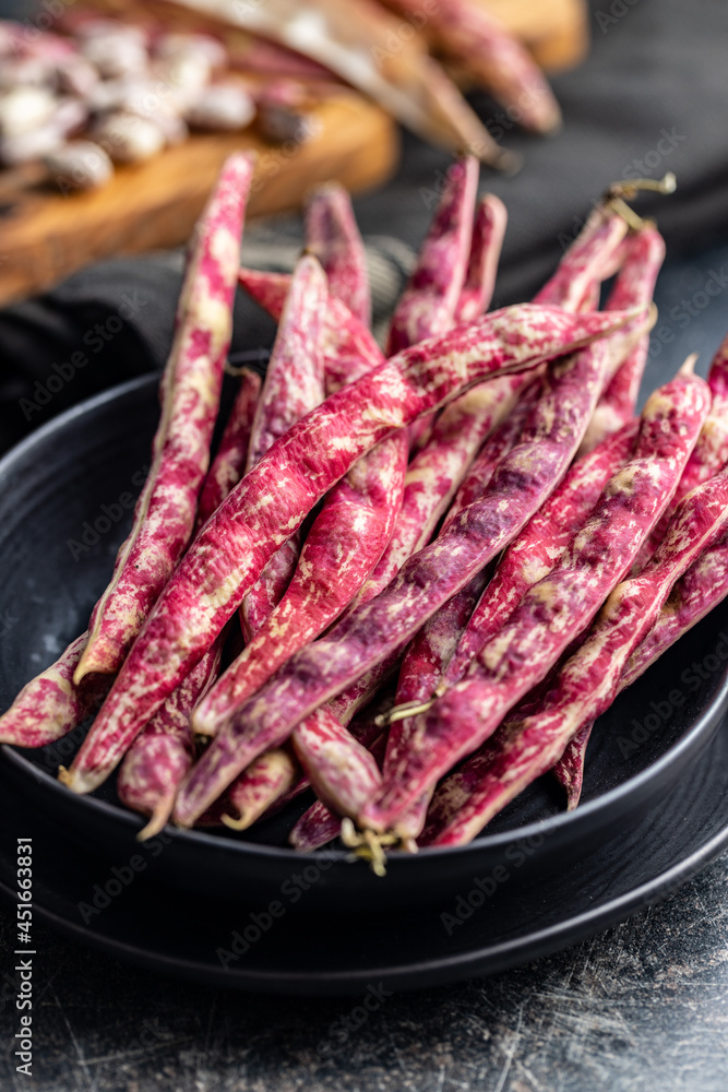Cranberry beans. Beans pods on plate.
