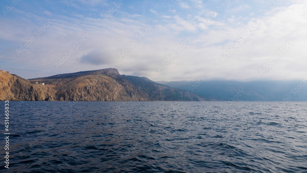 Fog over the coast, view from the sea Fog over the coast, view from the sea