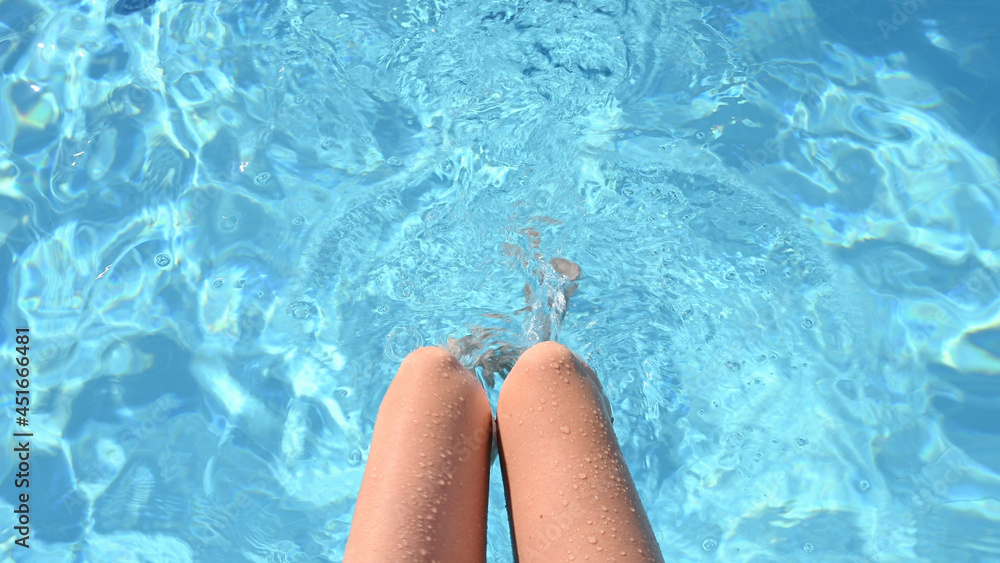 Female legs in the pool