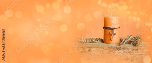 Candle with wooden cross and grain - greeting card and background for confirmation, communion, baptism