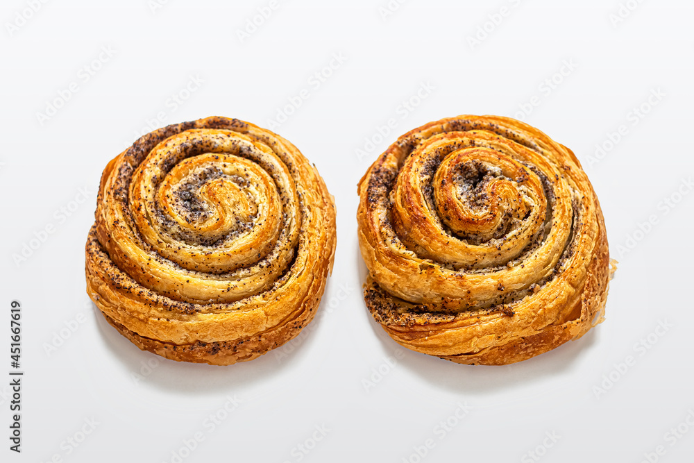 Sweet puff buns with poppy seeds on a light background Sweet puff buns with poppy seeds on a light background
