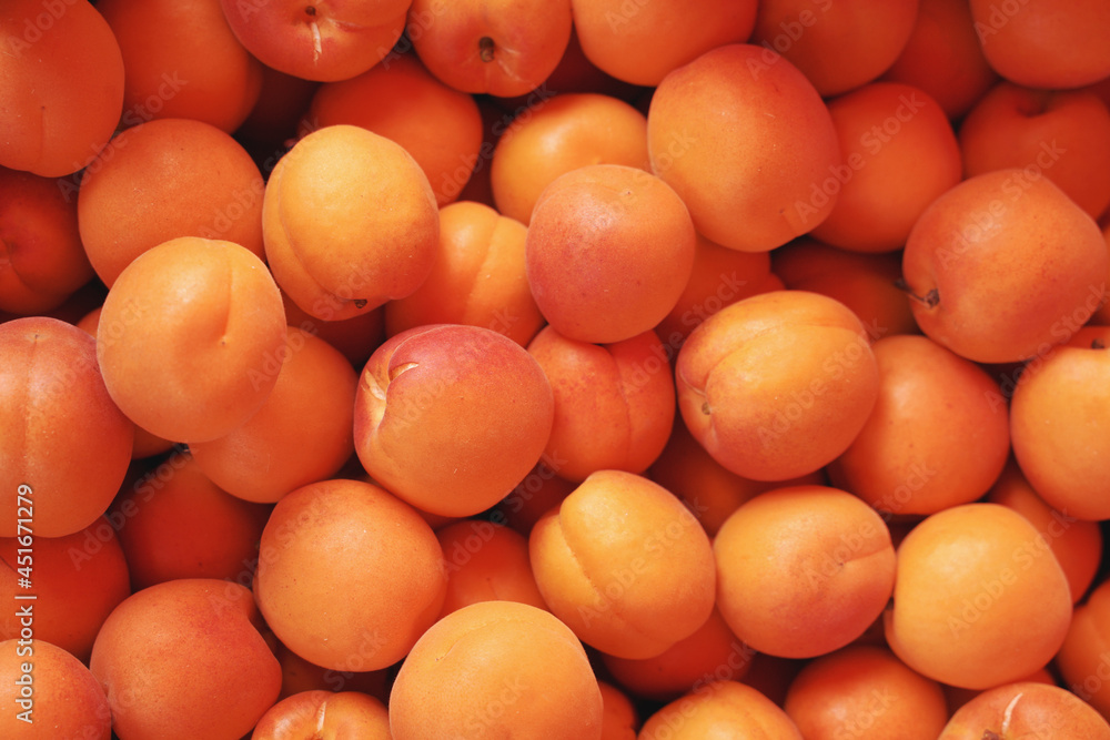 Ripe organic apricots on the market. Background, food texture, new harvest. Ripe organic apricots on the market. Background, food texture, new harvest.
