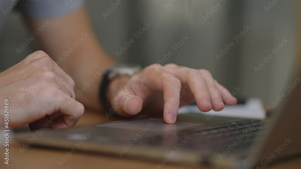 Close up hand of man scrolling a Website Using Laptop Track Pad. Computer keyboard. Using Touchpad Of Laptop. The man is finger scrolls presses and zooms on the laptop touchpad close-up Close up hand of man scrolling a Website Using Laptop Track Pad. Computer keyboard. Using Touchpad Of Laptop. The man is finger scrolls presses and zooms on the laptop touchpad close-up